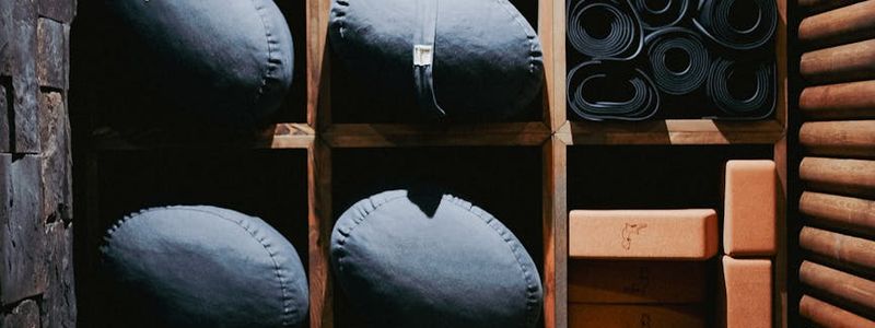 Row of yoga mats neatly rolled in a storage rack